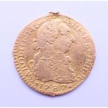 A 1787 gold Escudo coin. 1.75 cm diameter. 2.1 grammes.