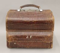 A crocodile skin Gladstone bag inscribed for James Fagan Malton. 35 cm wide.