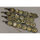 A quantity of horse brasses on leather straps. Each strap approximately 57 cm high.