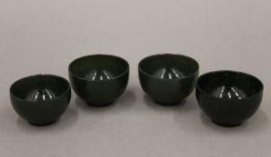 A set of four Oriental jade wine cups. 5 cm diameter.