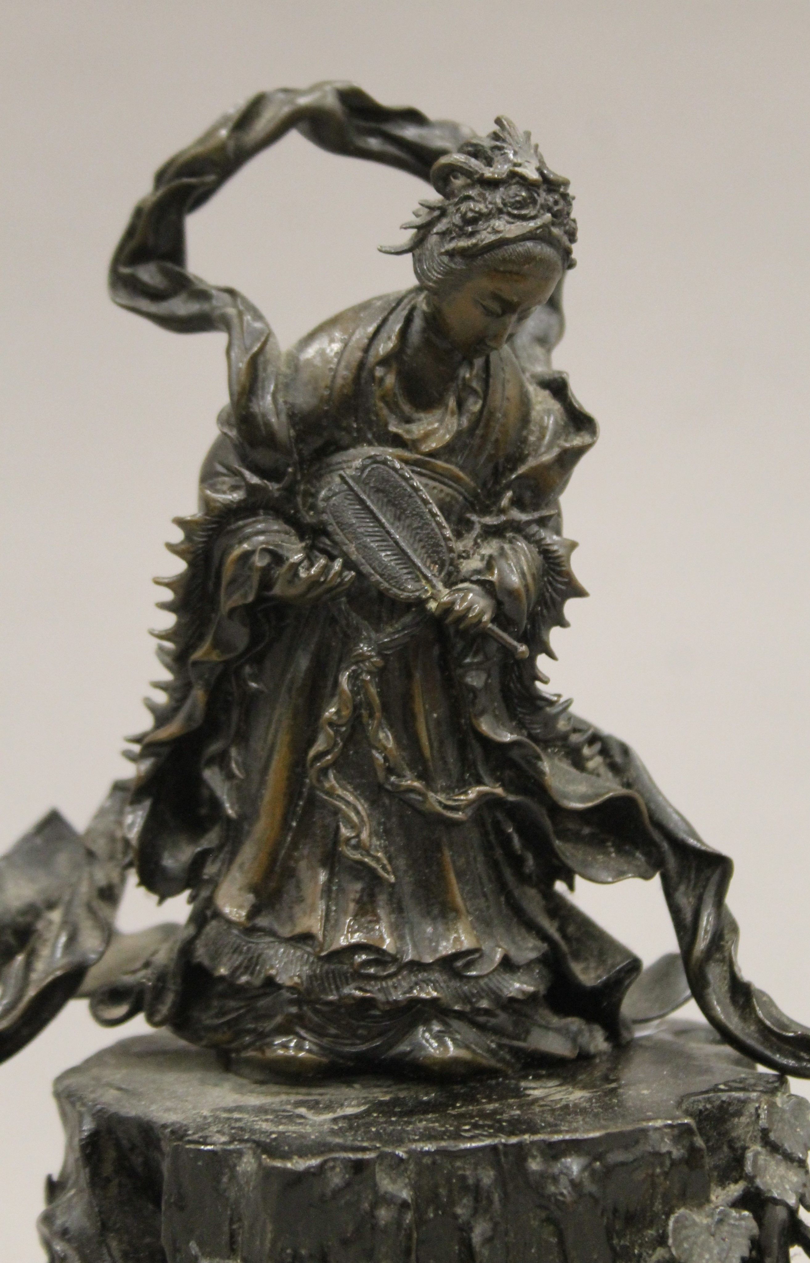 A 19th century Oriental bronze figure of Guanyin standing on a cast rockwork base with dragons. - Image 2 of 5