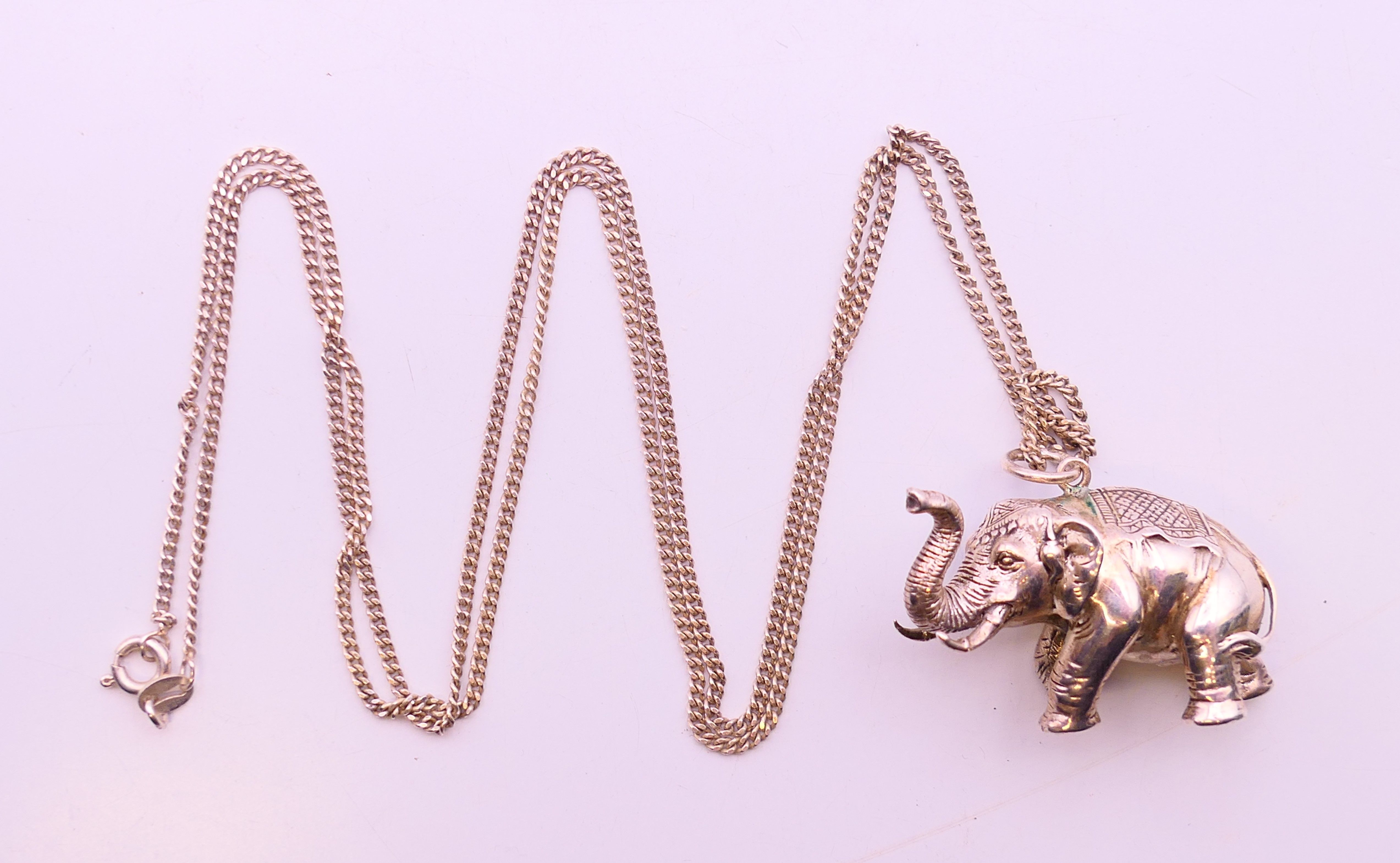 A silver hallmarked elephant pendant on a silver chain. Elephant 4 cm x 2.5 cm, chain 74 cm long. - Image 3 of 6