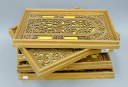 Six various fret carved wooden panels, each framed. The largest 35.5 x 45 cm.