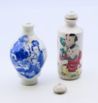 Two Chinese porcelain snuff bottles and stoppers. Each approximately 8.5 cm high.