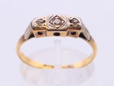 An 18 ct gold Art Deco three stone diamond ring. Ring size P.