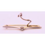 An unmarked gold and diamond bar brooch. 6 cm wide. 4.6 grammes total weight.