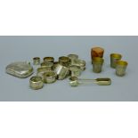 A quantity of silver napkin rings, a silver hip flask (lacking lid),