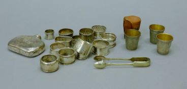A quantity of silver napkin rings, a silver hip flask (lacking lid),
