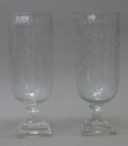 A pair of glass hurricane lamps. 40.5 cm high.