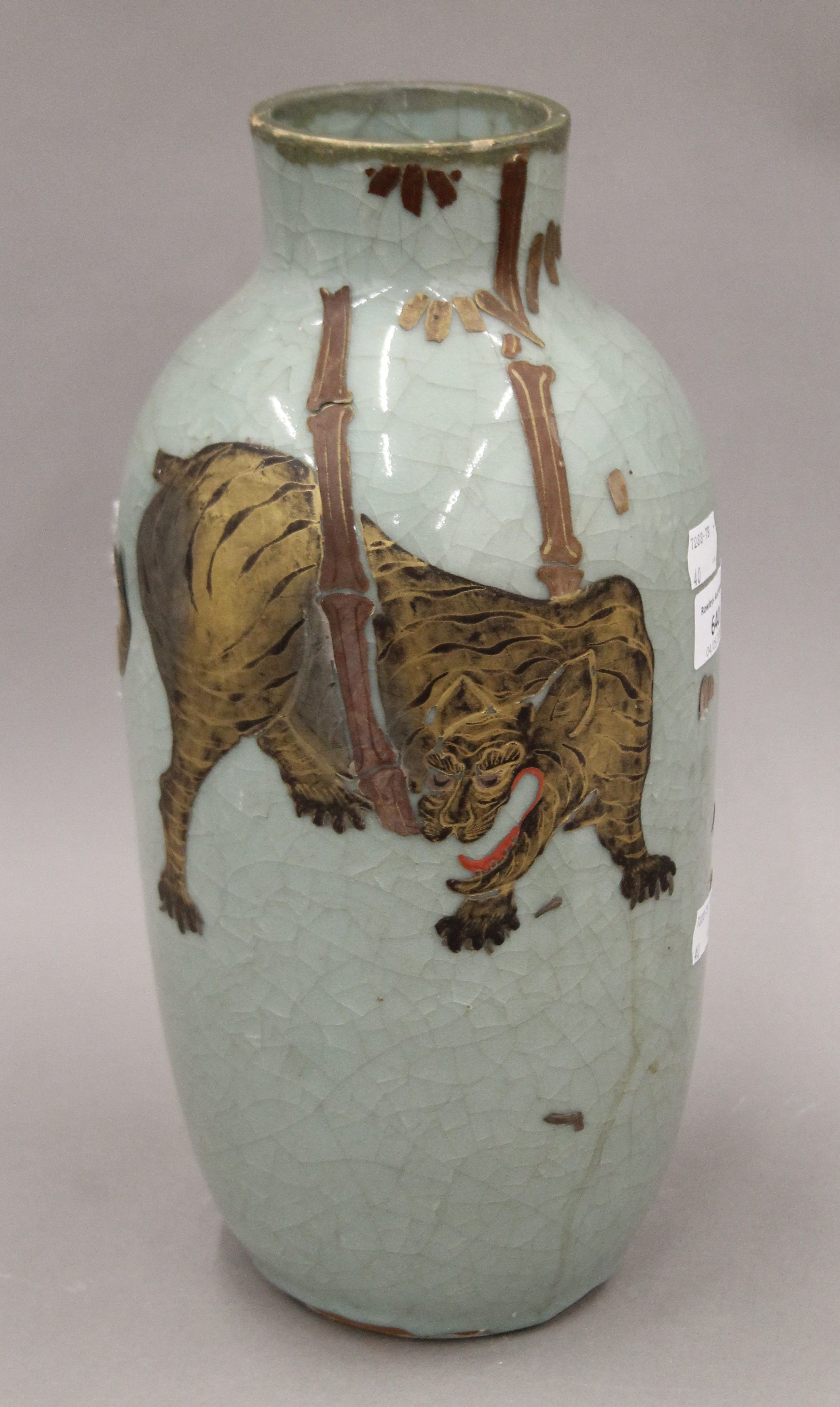 An Oriental celadon ground vase decorated with a tiger. 34 cm high.