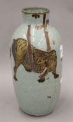 An Oriental celadon ground vase decorated with a tiger. 34 cm high.
