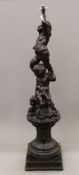 A 19th century carving of two putti seated on a C-scroll and acanthus carved pedestal base (later