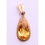 A 9 ct gold citrine pendant. 2.5 cm high.