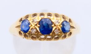 An 18 ct gold, diamond and sapphire ring. Ring size P/Q.