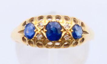 An 18 ct gold, diamond and sapphire ring. Ring size P/Q.