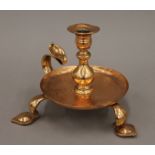An Arts and Crafts chamberstick in the manner of W A S Benson. 14 cm high.