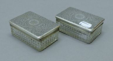 Two silver-lidded cut glass boxes. Each 9.5 cm long. 125.