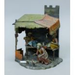 A cold-painted bronze of an Arab shop. 23.5 cm high.