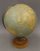 An early 20th century revolving terrestrial globe on a stand. 48 cm high.