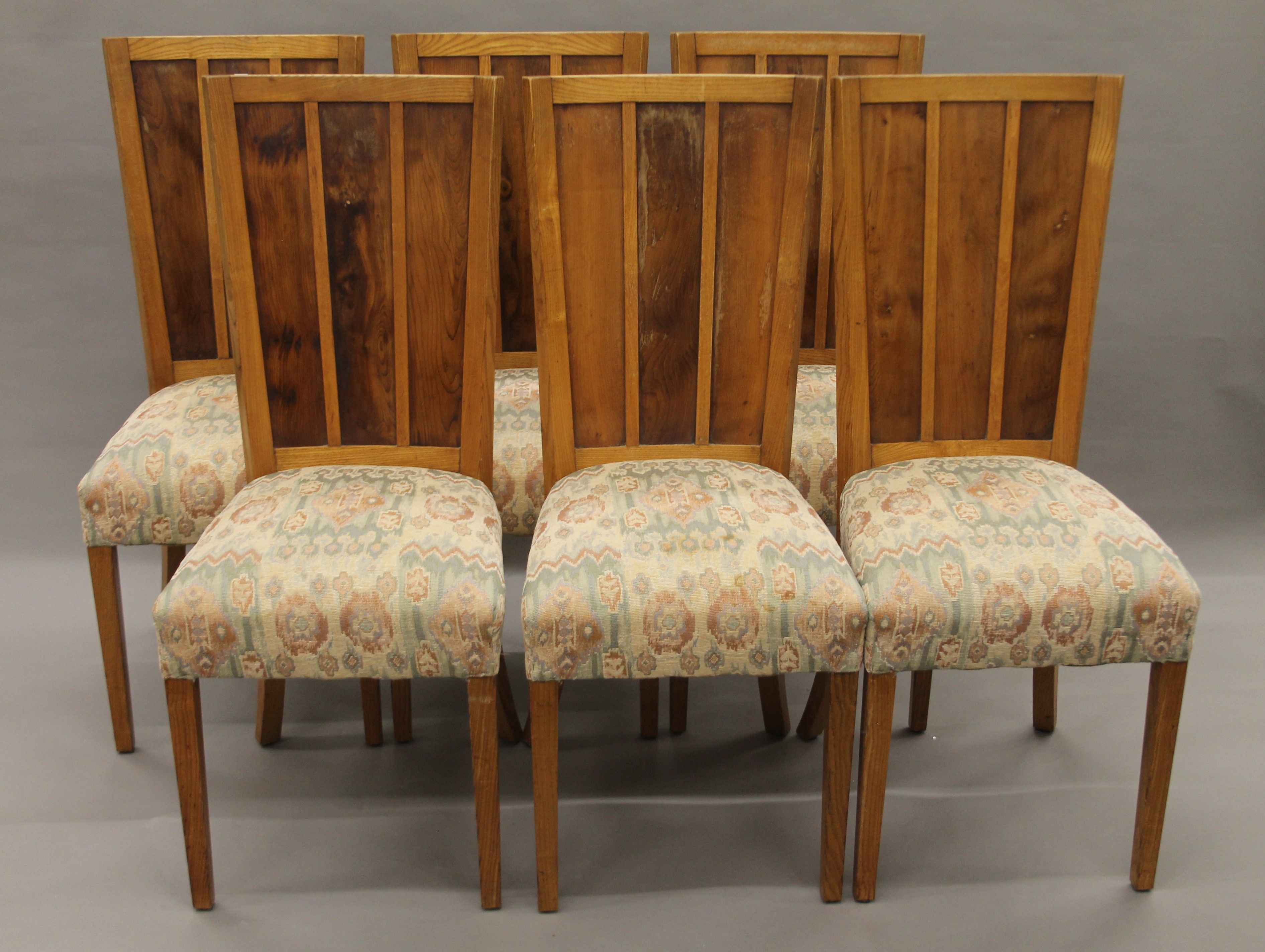 A set of six early 20th century oak and yew wood dining chairs. 45 cm wide.