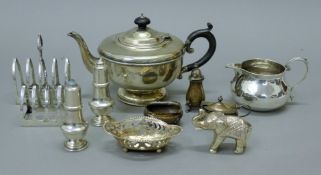 A quantity of various silver. including teapot, two toast racks, cruets etc. The former 24 cm long.