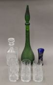 A green bottle, a whiskey decanter, six glasses and a silver-clad glass vase. The latter 16 cm high.