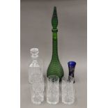 A green bottle, a whiskey decanter, six glasses and a silver-clad glass vase. The latter 16 cm high.