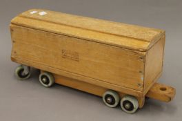 An Adventure Playthings of Glenrothe's, Fife wooden railway carriage. 57 cm long.