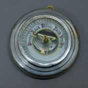 A silver-clad barometer. 13.5 cm diameter.