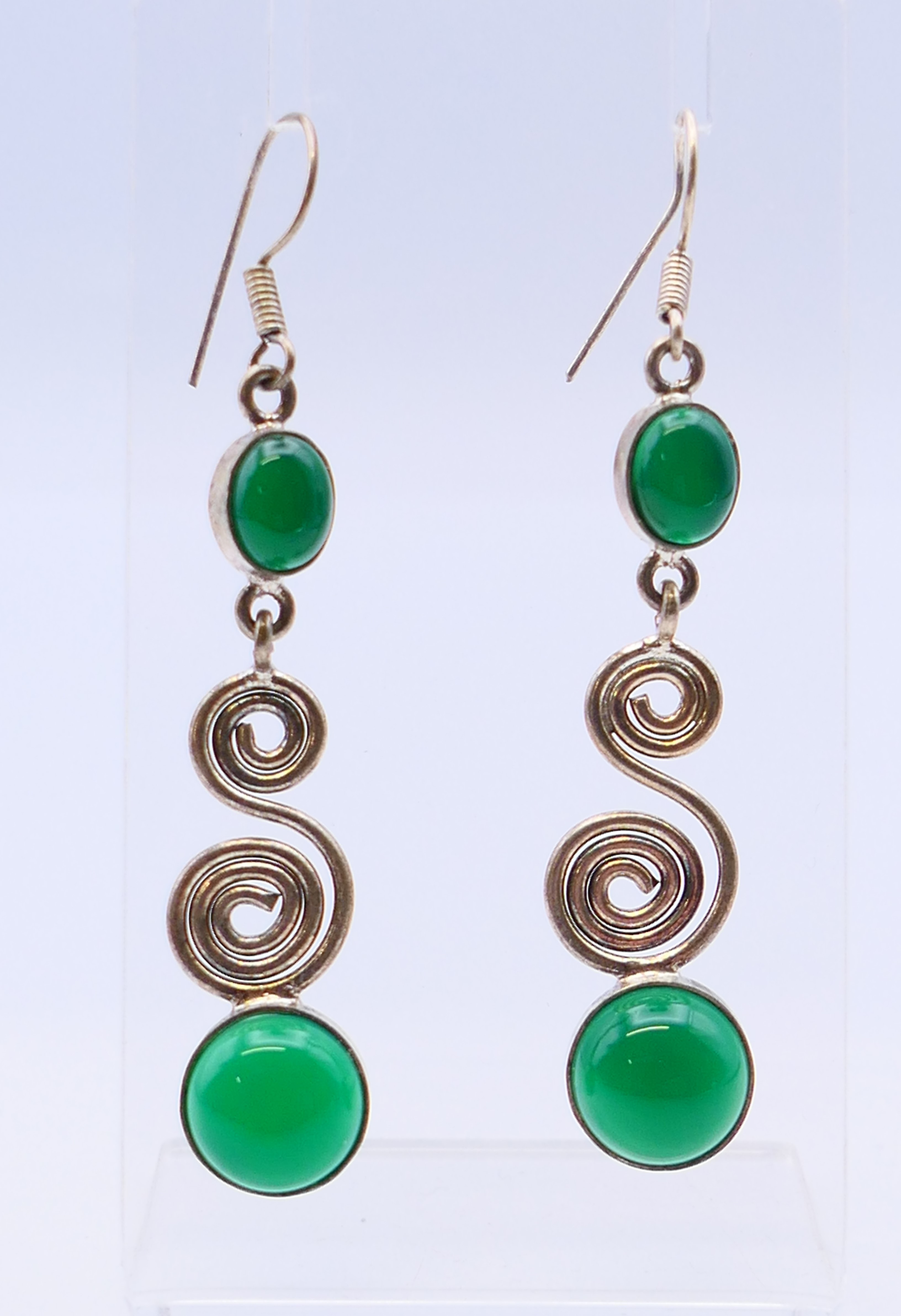 A pair of jade and silver earrings. 6 cm high.