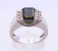 A rectangular tourmaline and diamond dress ring with forty-eight brilliant cut diamonds to the