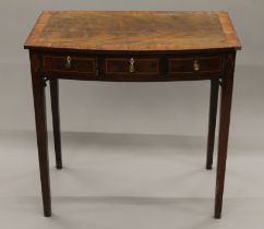 A 19th century mahogany bow front three-drawer side table. 76.5 cm wide.