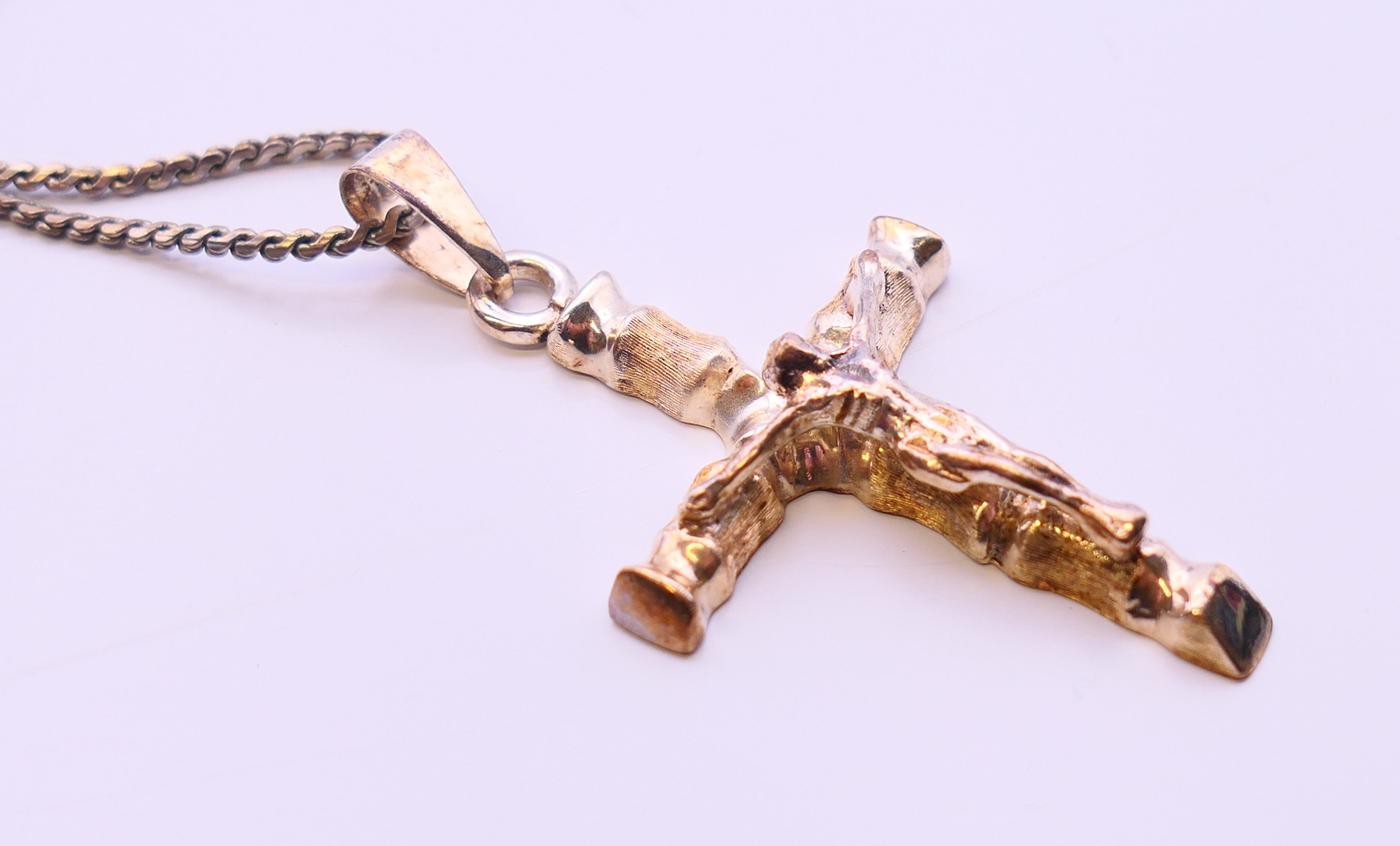 A silver crucifix on a silver chain. - Image 3 of 6