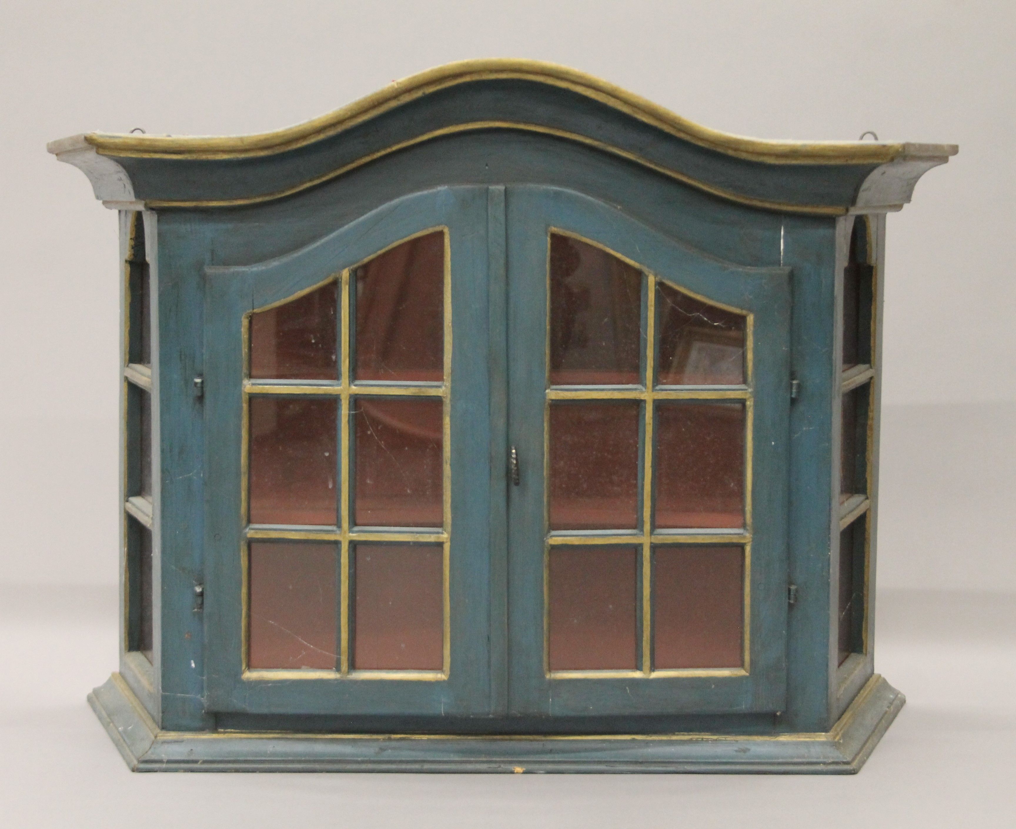 A green painted glazed wall cabinet. 91 cm wide.