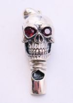 A silver whistle in the form of a skull. 4 cm high.
