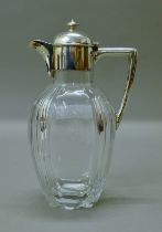 A silver-mounted glass claret jug. 22.5 cm high.