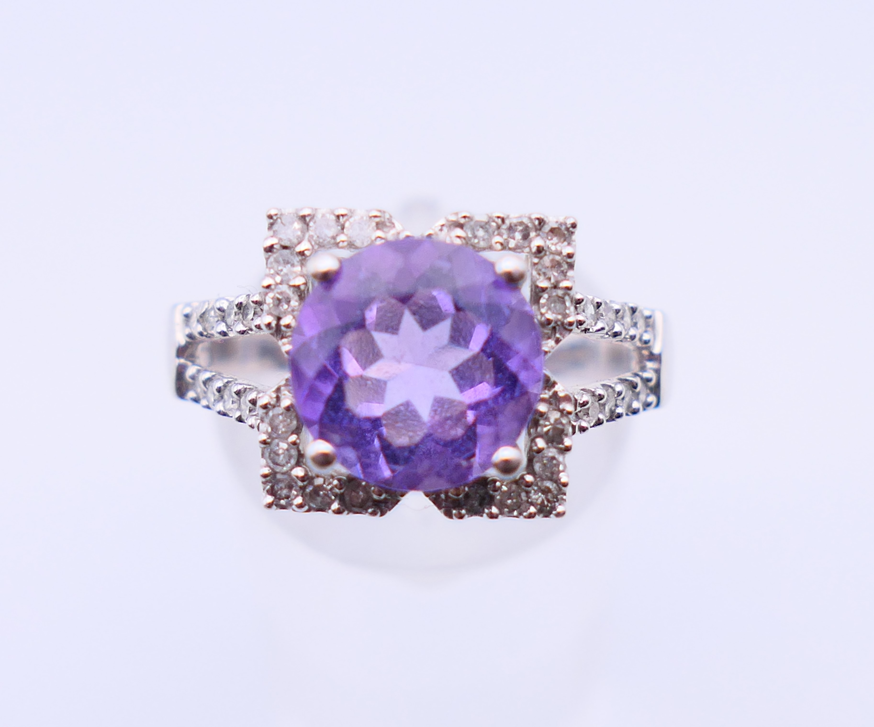 A 9 ct white gold, amethyst and diamond ring. 4.4 grammes. Ring size Q/R.