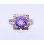 A 9 ct white gold, amethyst and diamond ring. 4.4 grammes. Ring size Q/R.