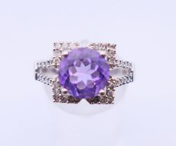 A 9 ct white gold, amethyst and diamond ring. 4.4 grammes. Ring size Q/R.