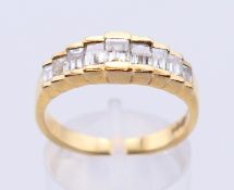 An 18 ct gold millennium cut nine stone ring graduating 2.5mm x 2mm to 3.3 x 2.8mm, estimated 0.