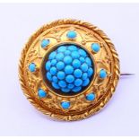 A boxed Victorian unmarked turquoise-set brooch. 3 cm diameter. 11.2 grammes total weight.