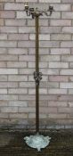 A brass candle stand. 143 cm high.