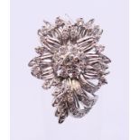 An unmarked platinum or white gold, diamond floral spray ring. 3cms long. Ring size Q/R.