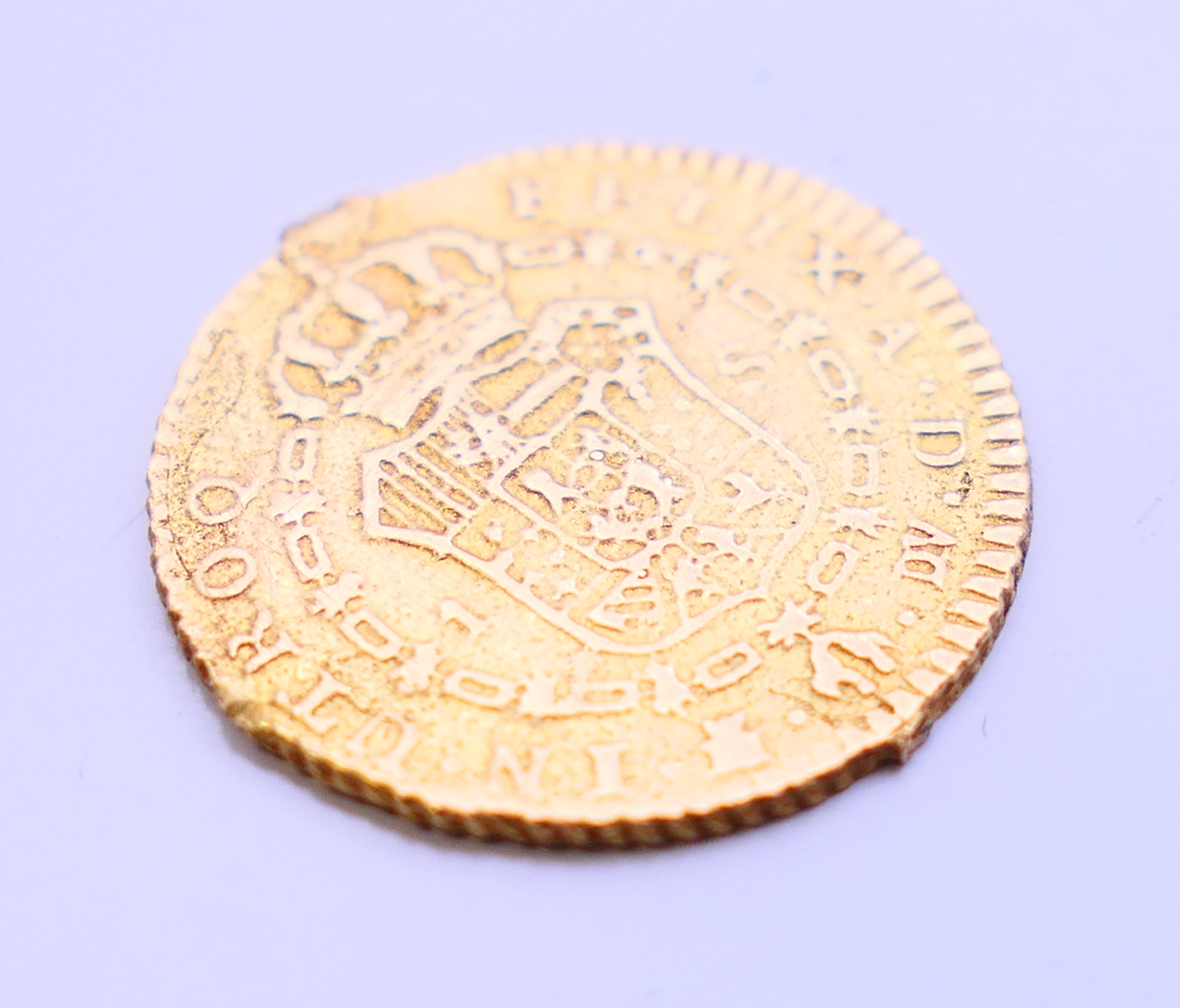 A 1787 gold Escudo coin. 1.75 cm diameter. 2.1 grammes. - Image 3 of 4