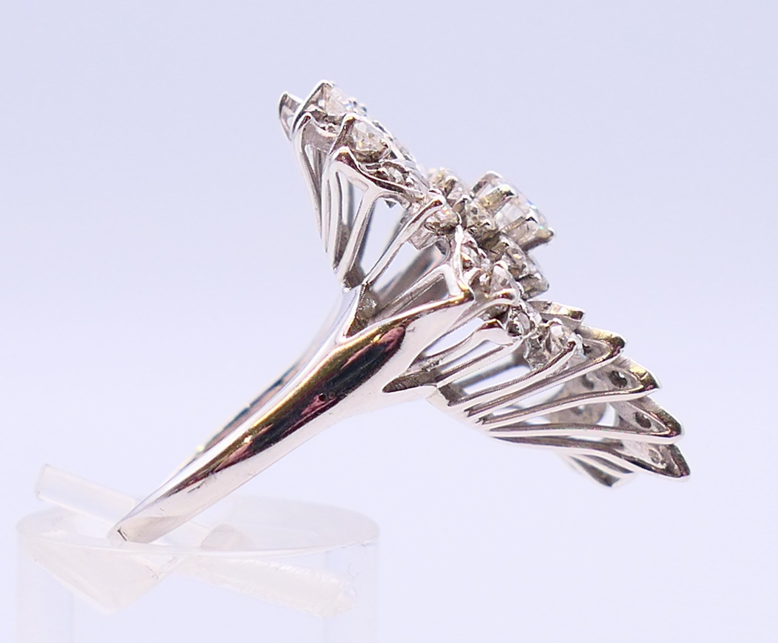 An unmarked platinum or white gold, diamond floral spray ring. 3cms long. Ring size Q/R. - Image 4 of 6