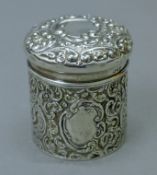 A Chester silver embossed lidded pot, the base stamped for Walker & Hall. 7.5 cm high. 94.8 grammes.