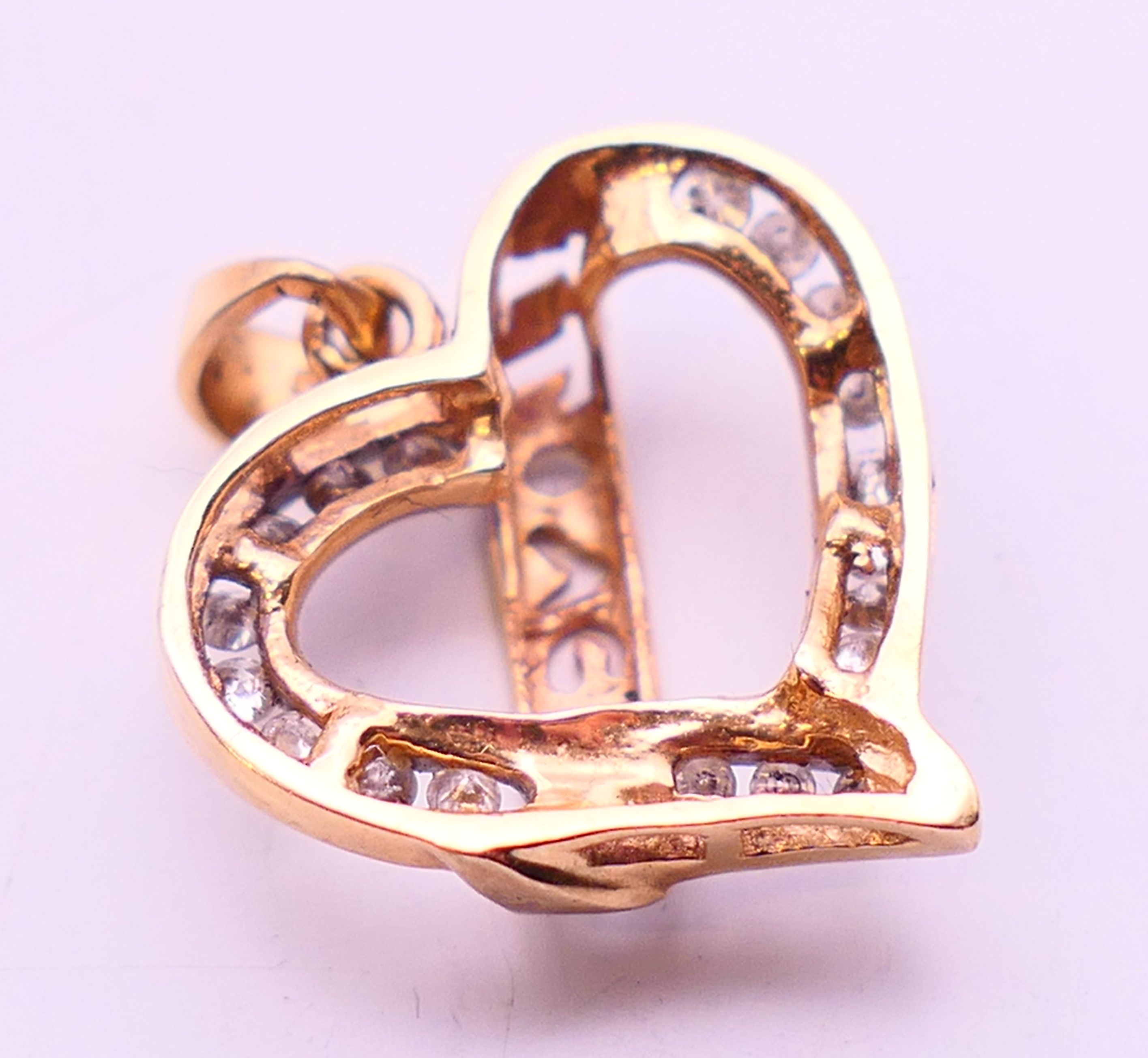 A 9 ct gold and diamond set 'I Love You' heart shaped pendant. 2.2 grammes. 2 cm high. - Image 4 of 4