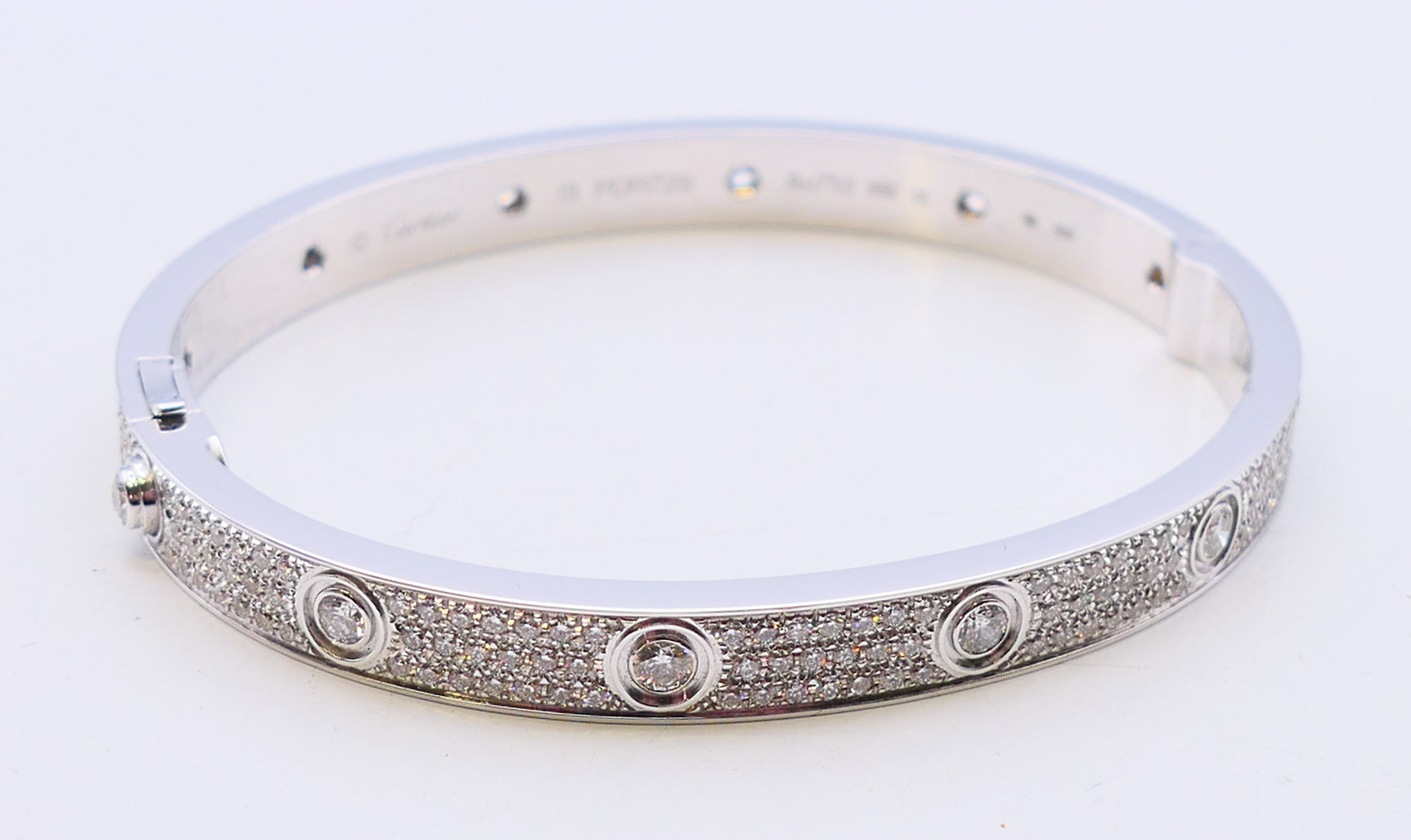 A Cartier 18 K white gold and diamond encrusted love bangle numbered 19 PDR729. 6.