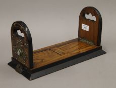 A Victorian Betjemann's brass and agate-mounted walnut sliding book rack. 34 cm long when closed.