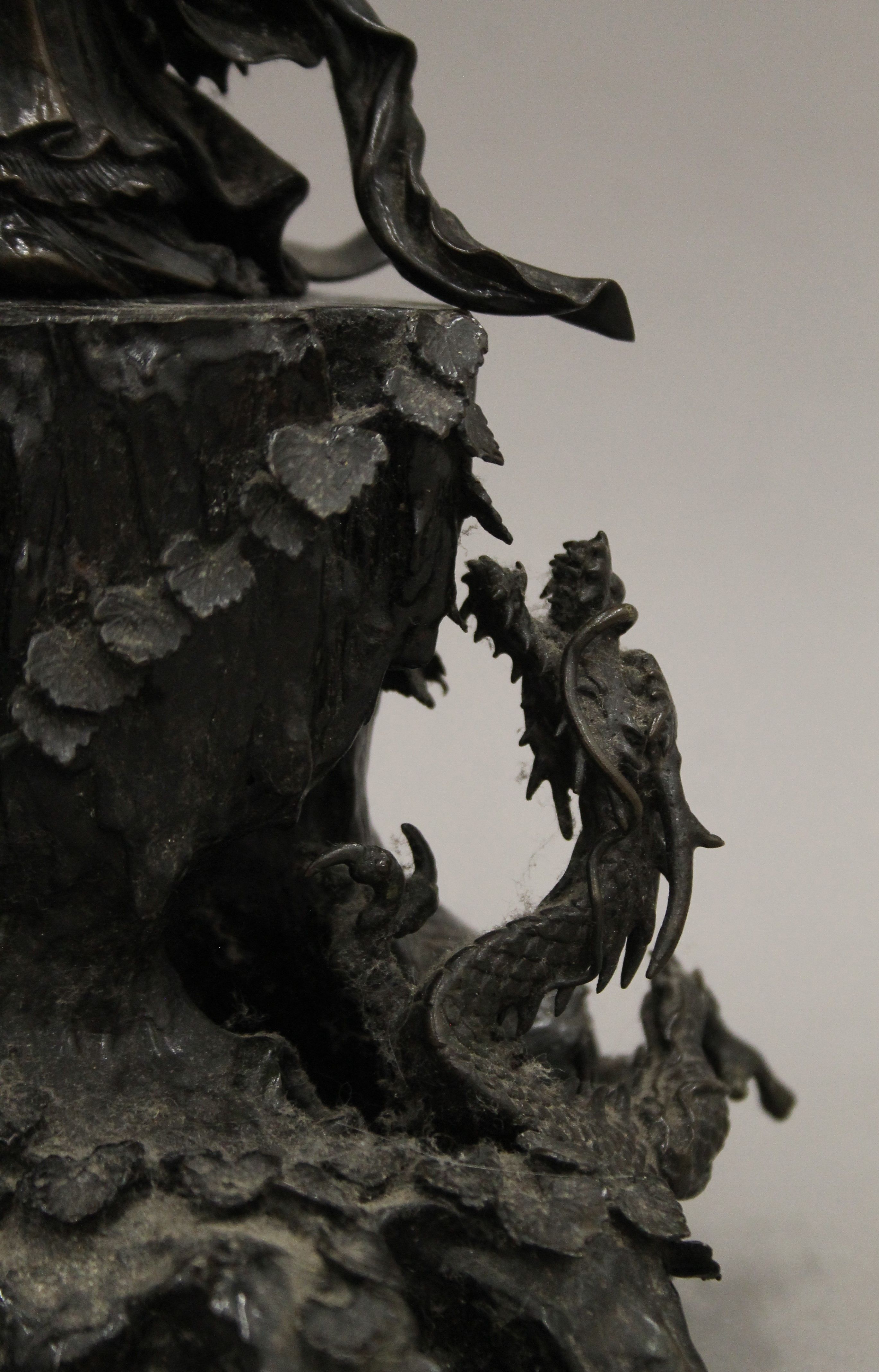 A 19th century Oriental bronze figure of Guanyin standing on a cast rockwork base with dragons. - Image 3 of 5